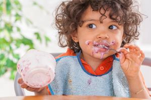toddler eating yogurt